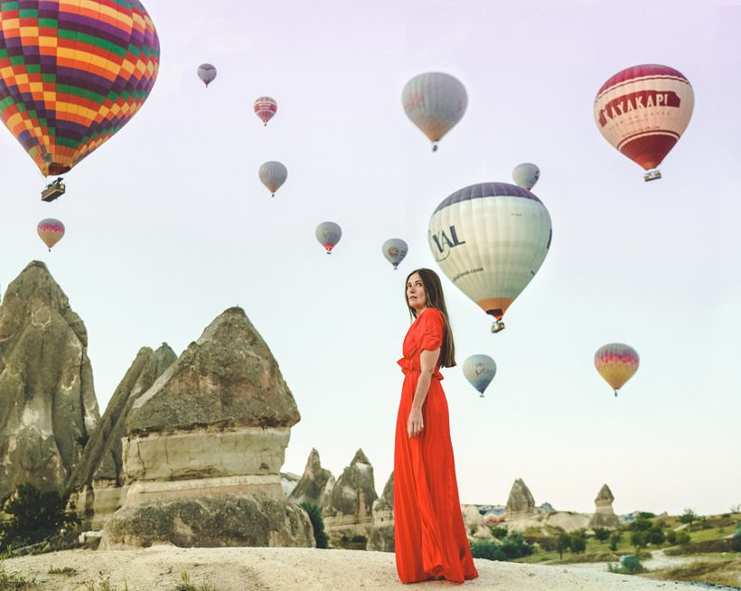 girl and a lot of hot air balloons